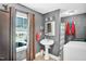 Bright bathroom with natural light featuring updated fixtures, pedestal sink, mirror, and stand-up shower at 708 W Pope St, Dunn, NC 28334
