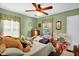 Bright bedroom with natural light, hardwood floors, and playful decor at 708 W Pope St, Dunn, NC 28334