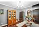 Traditional dining room with hardwood floors, china cabinet, and seating for elegant dinners and entertaining guests at 708 W Pope St, Dunn, NC 28334