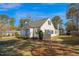 Exterior view showcases a beautifully landscaped yard, mature trees, and side of the home at 708 W Pope St, Dunn, NC 28334