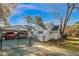 Rear exterior view featuring a covered carport, fenced yard, and well-maintained property at 708 W Pope St, Dunn, NC 28334