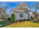 Charming home featuring a metal roof, white siding, and mature landscaping at 708 W Pope St, Dunn, NC 28334