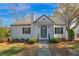 Charming front exterior featuring a well-maintained lawn, elegant entryway and dark shutters at 708 W Pope St, Dunn, NC 28334