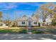 Charming home featuring a metal roof, landscaped yard, and inviting front entrance at 708 W Pope St, Dunn, NC 28334