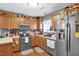 Efficient kitchen with ample counter space, stainless steel appliances, and wood cabinets at 708 W Pope St, Dunn, NC 28334