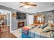 Spacious main bedroom with hardwood floors, ceiling fan, closet, and access to kitchen at 708 W Pope St, Dunn, NC 28334