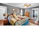 Spacious main bedroom with hardwood floors, ceiling fan, closet, and windows at 708 W Pope St, Dunn, NC 28334