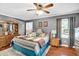 Spacious main bedroom with hardwood floors, ceiling fan, closet, and windows at 708 W Pope St, Dunn, NC 28334