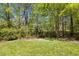 Lovely backyard features lush green grass and decorative stone edging at 725 Ancient Oaks Dr, Holly Springs, NC 27540