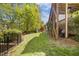 This well-manicured backyard has green grass and fencing at 725 Ancient Oaks Dr, Holly Springs, NC 27540