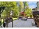 Backyard patio featuring a built-in fire pit with stone surround and wood storage at 725 Ancient Oaks Dr, Holly Springs, NC 27540