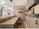 Close-up of the stylish bar area with custom shelving and granite countertop at 725 Ancient Oaks Dr, Holly Springs, NC 27540
