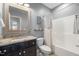 Cozy bathroom featuring a granite countertop, tub and shower, and updated fixtures at 725 Ancient Oaks Dr, Holly Springs, NC 27540