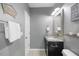 Well-lit bathroom featuring a granite countertop and decorative wall art at 725 Ancient Oaks Dr, Holly Springs, NC 27540