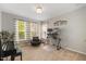 Bright bedroom with neutral carpeting, large windows, and a dedicated workspace at 725 Ancient Oaks Dr, Holly Springs, NC 27540