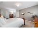 Well-lit bedroom features carpet floors, neutral colors, a TV, and a dresser with a decorative lamp at 725 Ancient Oaks Dr, Holly Springs, NC 27540