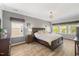 Spacious main bedroom features hardwood floors and two large windows, filling the room with lots of natural light at 725 Ancient Oaks Dr, Holly Springs, NC 27540