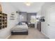 Bright bedroom with a single bed, study desk, and neutral walls at 725 Ancient Oaks Dr, Holly Springs, NC 27540