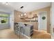 Open dining area with bar seating, pendant lighting, and a view of the backyard at 725 Ancient Oaks Dr, Holly Springs, NC 27540
