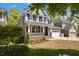Charming home with a covered front porch and well-kept landscaping at 725 Ancient Oaks Dr, Holly Springs, NC 27540