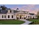 Elegant white home with a welcoming front porch and well-manicured lawn at 725 Ancient Oaks Dr, Holly Springs, NC 27540