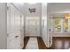 Spacious foyer with wood floors, a front door with glass, and white trim at 725 Ancient Oaks Dr, Holly Springs, NC 27540