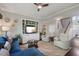 Bright living room features hardwood floors, ceiling fan and staircase to the second floor at 725 Ancient Oaks Dr, Holly Springs, NC 27540