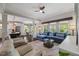 Open-concept living room and kitchen with dark floors, large windows, and modern furnishings at 725 Ancient Oaks Dr, Holly Springs, NC 27540