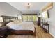 Spacious main bedroom features hardwood floors, large windows, and elegant decor at 725 Ancient Oaks Dr, Holly Springs, NC 27540