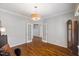 Bright room featuring wood floors, neutral walls, and french doors at 725 Ancient Oaks Dr, Holly Springs, NC 27540