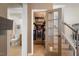 Spacious walk-in pantry with ample shelving and a glass door, next to stairs and a half bath at 725 Ancient Oaks Dr, Holly Springs, NC 27540
