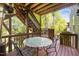 Outdoor patio area with dining table and seating, stairs to yard and grill at 725 Ancient Oaks Dr, Holly Springs, NC 27540