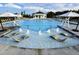 Community pool features in-pool lounge chairs with water fountain feature and plentiful seating at 725 Ancient Oaks Dr, Holly Springs, NC 27540