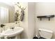 Neat bathroom with pedestal sink and toilet at 7528 Argent Valley Dr, Raleigh, NC 27616