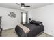 Comfortable bedroom with modern metal wall art and a ceiling fan at 7528 Argent Valley Dr, Raleigh, NC 27616