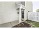 Charming entryway with decorative black door and adjacent white picket fence at 7528 Argent Valley Dr, Raleigh, NC 27616