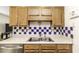 Practical kitchen with stainless steel sink and wooden cabinets at 7528 Argent Valley Dr, Raleigh, NC 27616