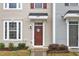 Close up of the front door featuring stylish details and manicured landscaping around the entrance at 8601 Red Canyon Way, Raleigh, NC 27616