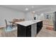 Kitchen area with stainless steel appliances, dark cabinets, and a center island with sink and dishwasher at 8601 Red Canyon Way, Raleigh, NC 27616