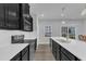 Kitchen with white countertops, stainless appliances, dark cabinets, and an island with sink and bar seating at 8601 Red Canyon Way, Raleigh, NC 27616