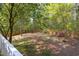Expansive backyard featuring mature trees and fenced perimeter, perfect for outdoor activities at 901 Clifford Dr, Durham, NC 27704