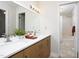 Bright bathroom featuring double vanity with wood cabinets, quartz countertop, and adjacent shower at 901 Clifford Dr, Durham, NC 27704