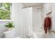 Cozy bathroom featuring a tub with shower, neutral walls, and a window with outdoor views at 901 Clifford Dr, Durham, NC 27704