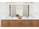 Modern bathroom showcasing a double vanity with wood cabinets, quartz countertop, and stylish fixtures at 901 Clifford Dr, Durham, NC 27704