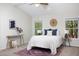 Bright bedroom featuring vaulted ceiling, neutral walls, and a large window with peaceful outdoor views at 901 Clifford Dr, Durham, NC 27704