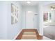 Bright foyer with wood floors, white walls, and a view into the living area at 901 Clifford Dr, Durham, NC 27704