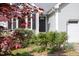 Close up of home's front door, surrounded by greenery, with black shutters at 901 Clifford Dr, Durham, NC 27704