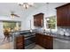 Kitchen features a breakfast bar, granite countertops and stainless appliances connecting to a dining area at 901 Clifford Dr, Durham, NC 27704