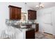 Well-lit kitchen with granite countertops, bar seating, tile backsplash and stainless steel appliances at 901 Clifford Dr, Durham, NC 27704
