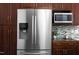Updated kitchen features a stainless steel refrigerator, microwave, and granite countertops at 901 Clifford Dr, Durham, NC 27704